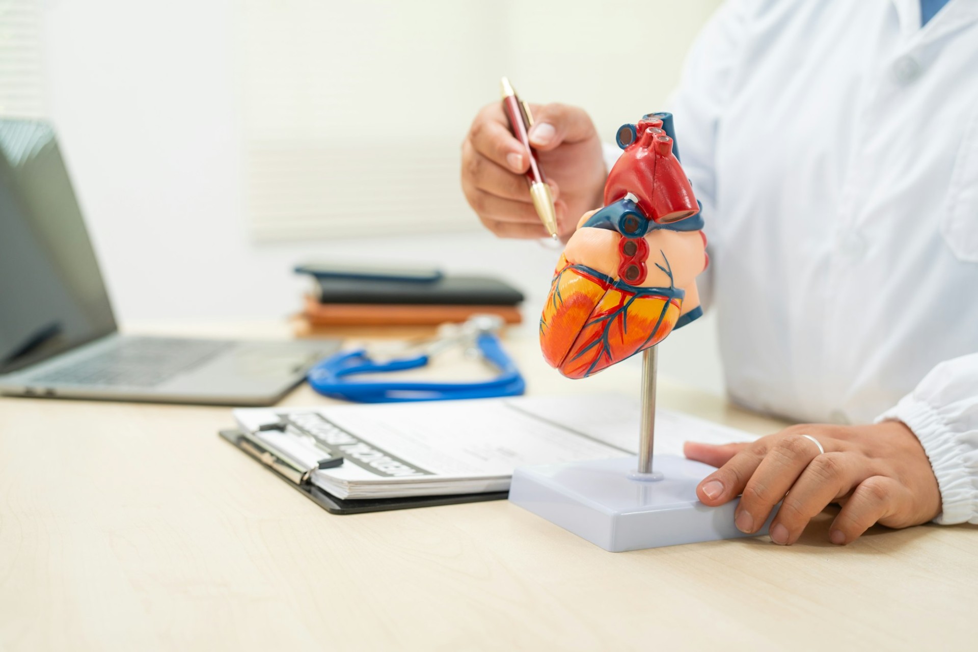 A female doctor works at desk in hospital,discussing heart diseases such coronary artery disease,